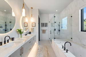 Bathroom featuring a marble finish shower, double vanity, a garden tub, light tile patterned floors, and recessed lighting
