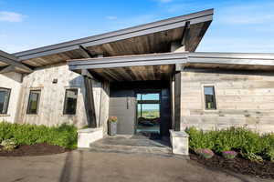 Entrance to property featuring stone siding