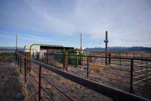 View of yard with a view of countryside, an exterior structure, an outbuilding, and a mountain view