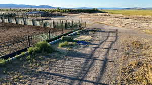 View of dirt / gravel road with a mountain view and a rural view