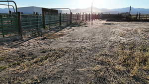 View of yard featuring a mountain view, a view of countryside, an exterior structure, and an outbuilding