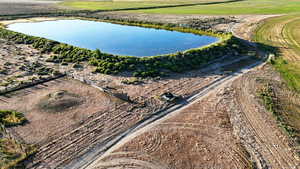 Aerial view of property and surrounding area featuring a large body of water
