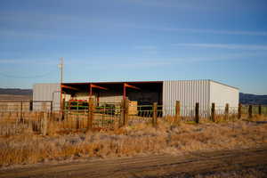 View of pole building with an exterior structure and a view of countryside