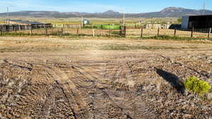 View of yard with a rural view and a mountain view