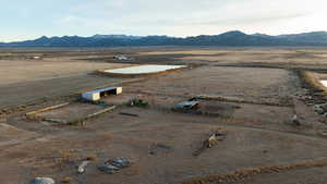 Aerial view of sparsely populated area featuring a desert landscape and a mountainous background
