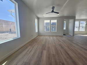 Unfurnished living room featuring wood finished floors, ceiling fan, and recessed lighting