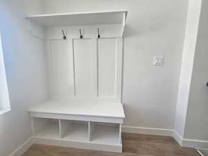 Mudroom featuring wood finished floors and baseboards