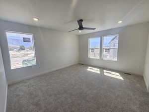 Empty room with carpet flooring, a ceiling fan, and recessed lighting