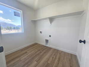 Washroom featuring wood finished floors, hookup for a washing machine, electric dryer hookup, and a mountain view