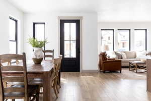 Dining space with light wood-style floors and baseboards