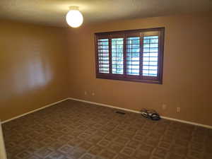 Spare room with a textured ceiling