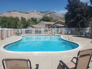Community pool with a patio and a mountain view
