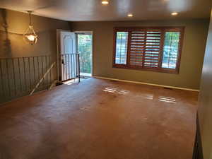 Carpeted entrance foyer with plenty of natural light, recessed lighting, and a textured ceiling