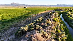 View of mountain background with rural landscape and a nearby body of water