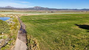View of mountain backdrop featuring rural landscape and a large body of water