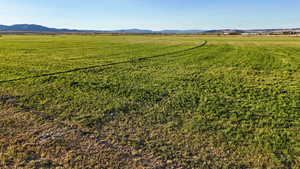 Aerial view of sparsely populated area with agricultural land and a mountainous background