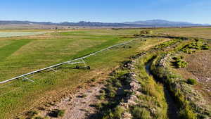 Overview of rural landscape featuring a mountain backdrop and agricultural land