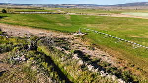 Aerial view of sparsely populated area featuring a water and mountain view