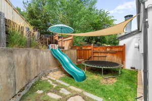 View of jungle gym featuring a trampoline