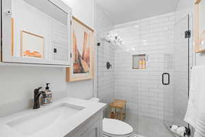 Bathroom with vanity and a stall shower