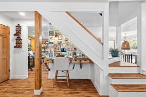 Staircase with wood finished floors and baseboards