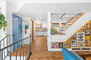 Hall featuring light wood-style floors and stairs