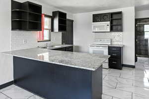 Kitchen with open shelves, light marble finish floors, a peninsula, white appliances, and a textured ceiling