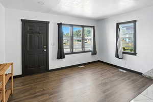 Entryway featuring a textured ceiling and dark wood-style flooring