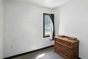 Bedroom featuring baseboards and carpet flooring