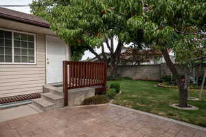 View of the east side of the backyard & patio with exterior door from the upstairs family room.