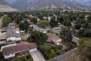 View of aerial property location with nearby suburban area and a mountain backdrop