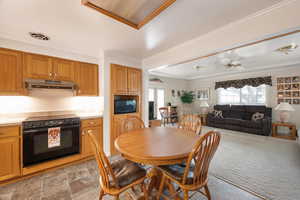Dining space with crown molding.