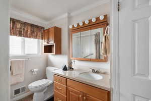 Full bath with vanity, a shower with shower curtain, crown molding, and dark tile patterned flooring