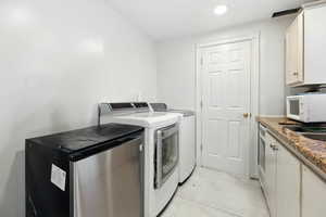 Laundry room with washer and dryer and recessed lighting
