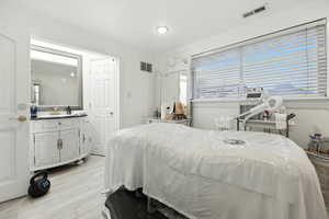 Bedroom with ornamental molding and light wood-type flooring
