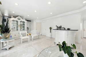 Living area featuring ornamental molding, recessed lighting, and tile patterned floors