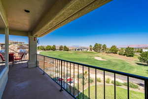 Balcony featuring view of golf course and a grill
