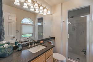 Bathroom featuring vanity and a stall shower