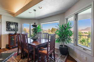 Dining area featuring recessed lighting, dark wood-style floors, and a textured ceiling