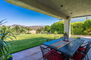 View of patio with a mountain view and outdoor dining area