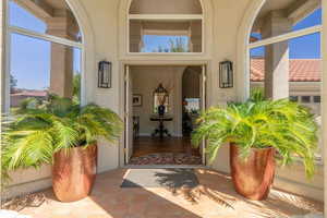 Entrance to property with stucco siding
