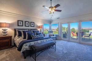 Carpeted bedroom featuring a textured ceiling, access to exterior, ceiling fan, and crown molding