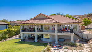 Rear view of house with a patio, stairway, a tile roof, and stucco siding