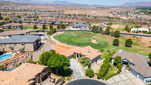 Aerial perspective of suburban area with a mountainous background and a golf course