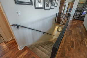 Stairs featuring wood finished floors and baseboards