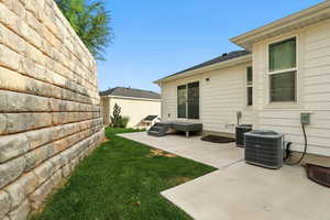 View of grassy yard featuring a patio