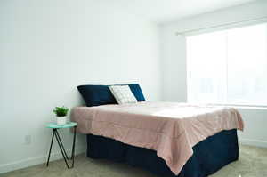 Bedroom with baseboards and carpet flooring