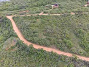 Aerial view of property and surrounding area featuring a heavily wooded area