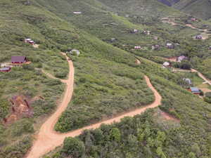 Aerial view of property and surrounding area featuring a forest