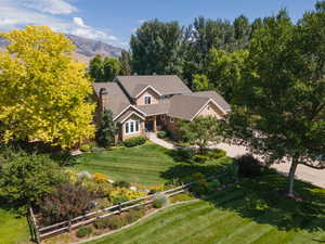 View of front of house with a mountain view, concrete driveway, a garage, and covered porch